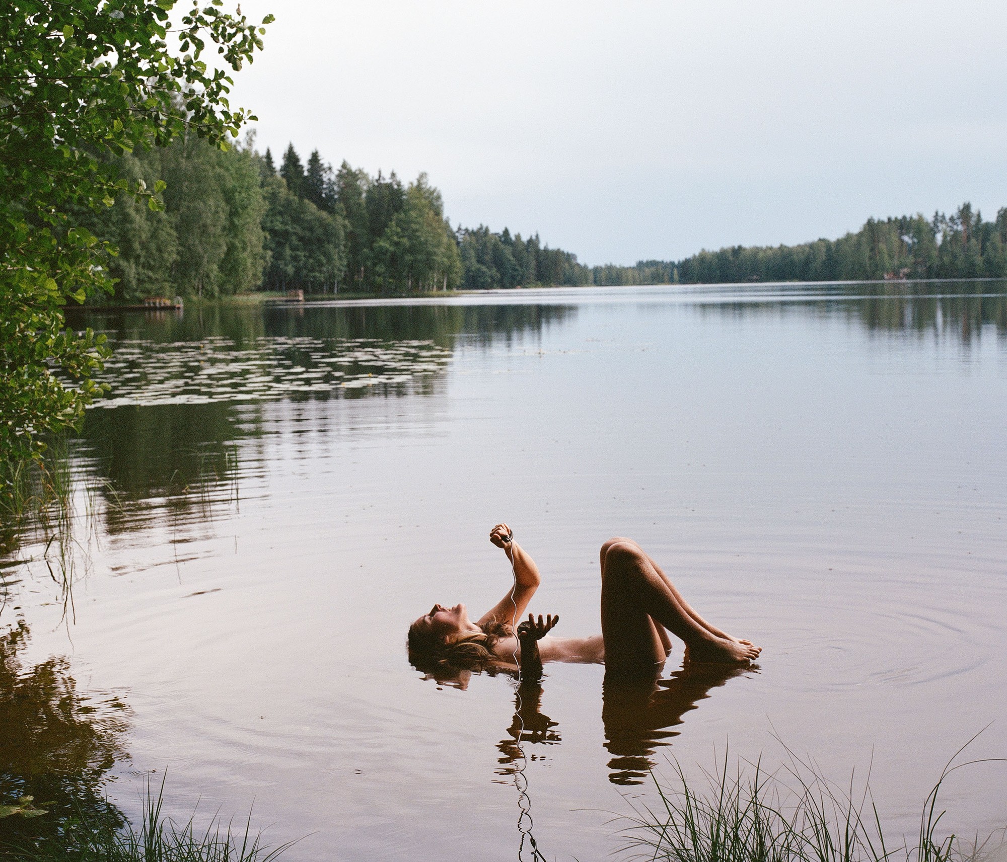 Self portrait of the artist floating in a lake