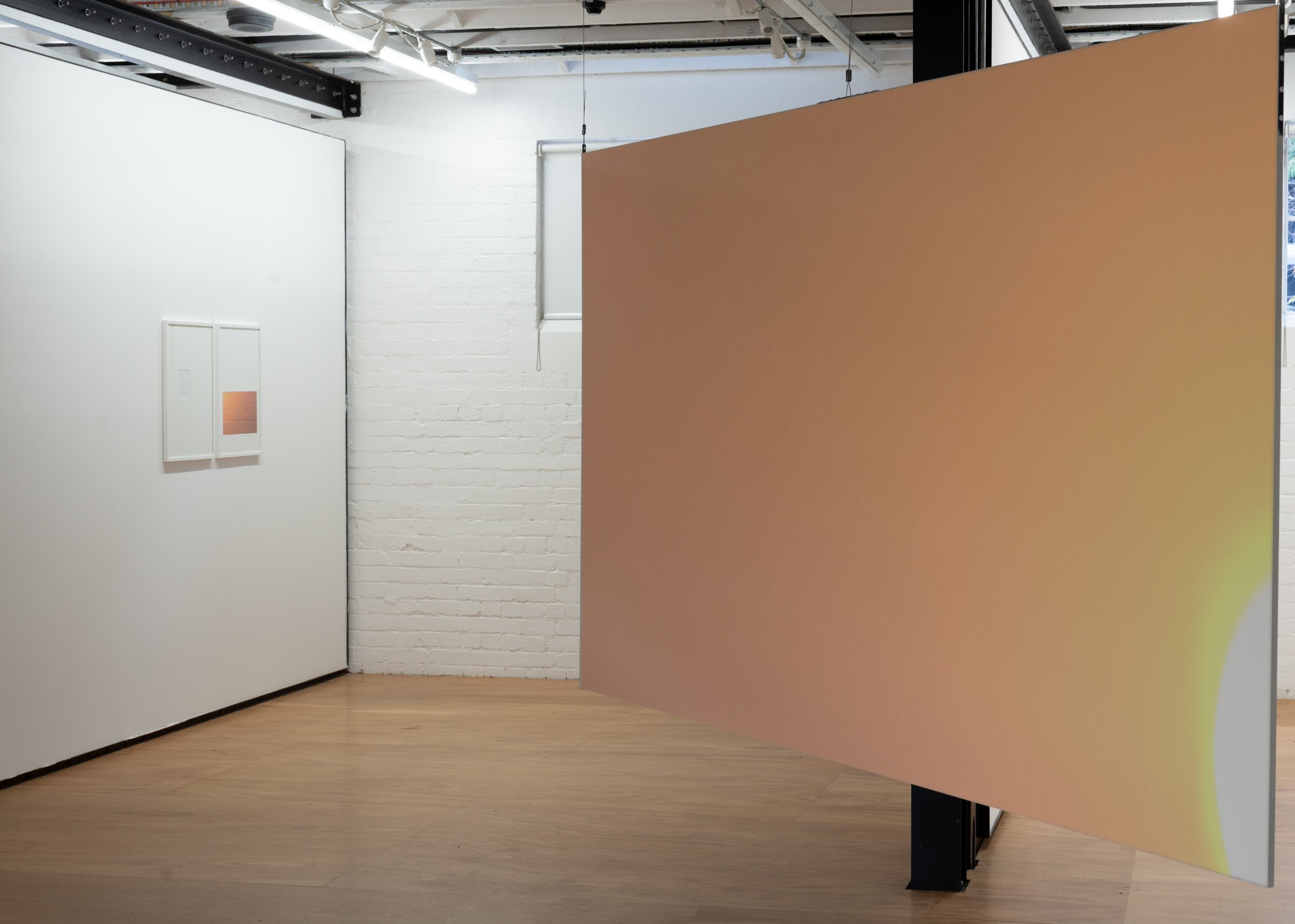 Auto Sun installation, orange partition wall in gallery