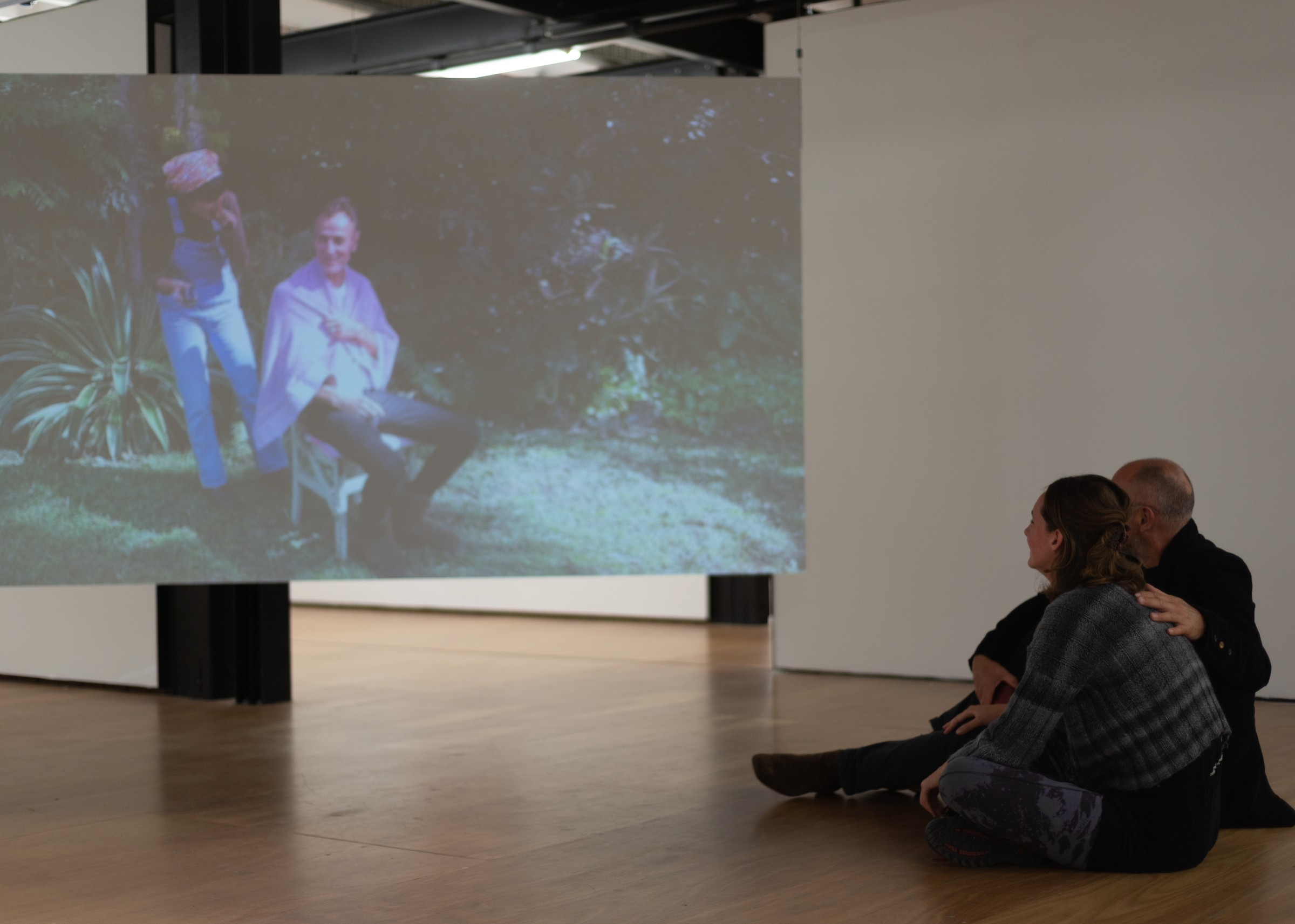 Auto Sun performance, audience seated watching a garden video projection