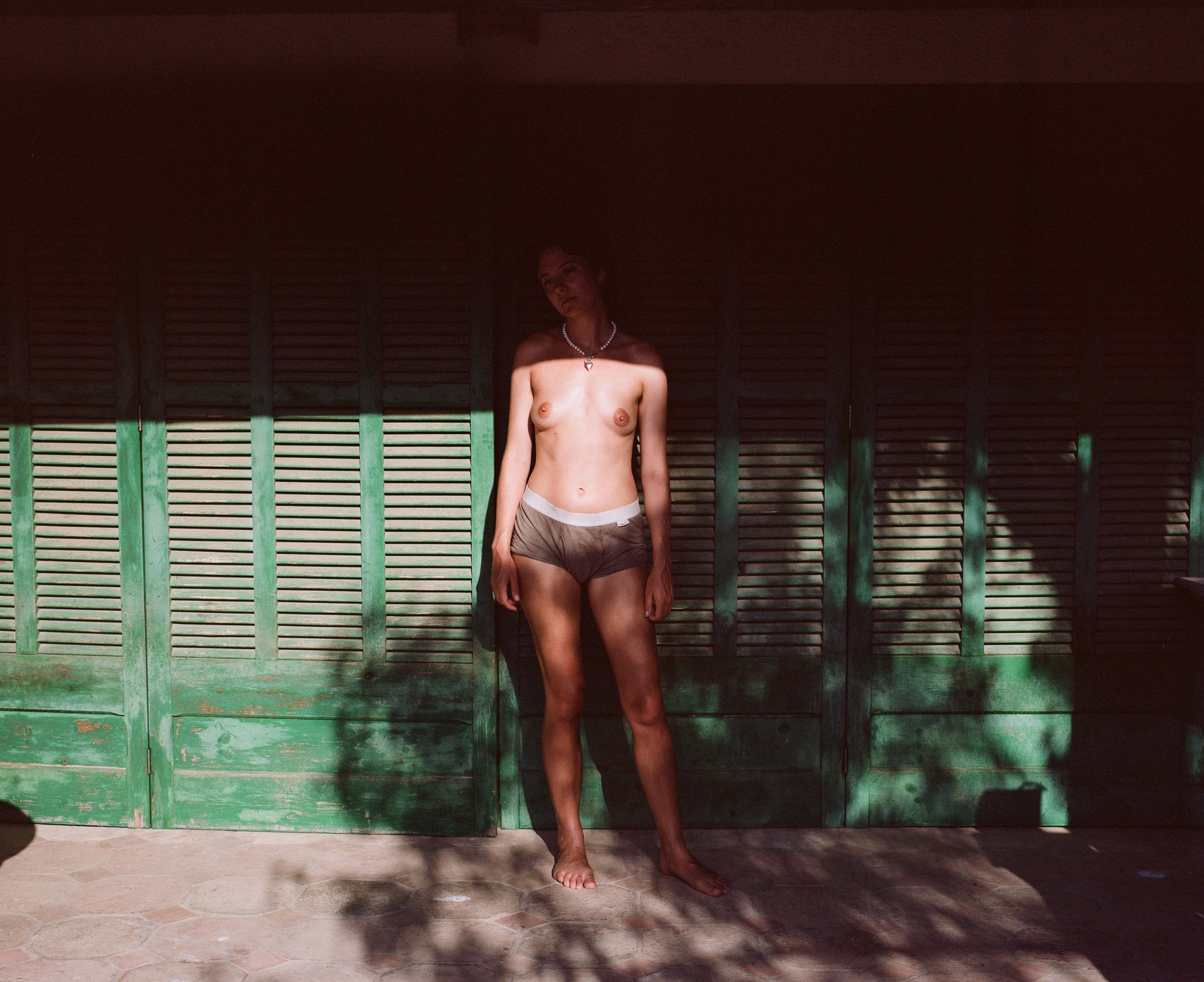 Portrait against green shutters