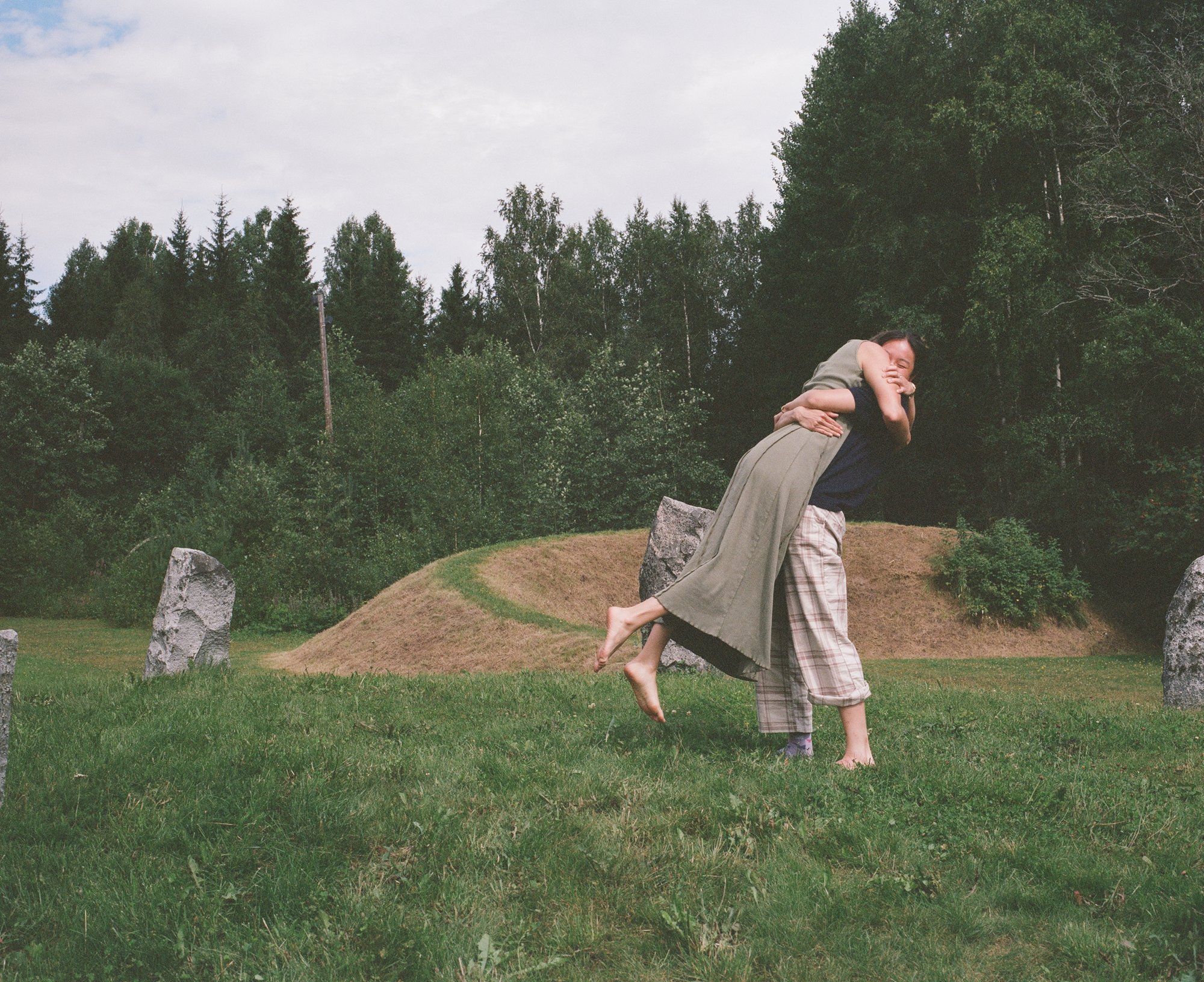 Two figures embracing, one leaning back with feet lifted off the ground