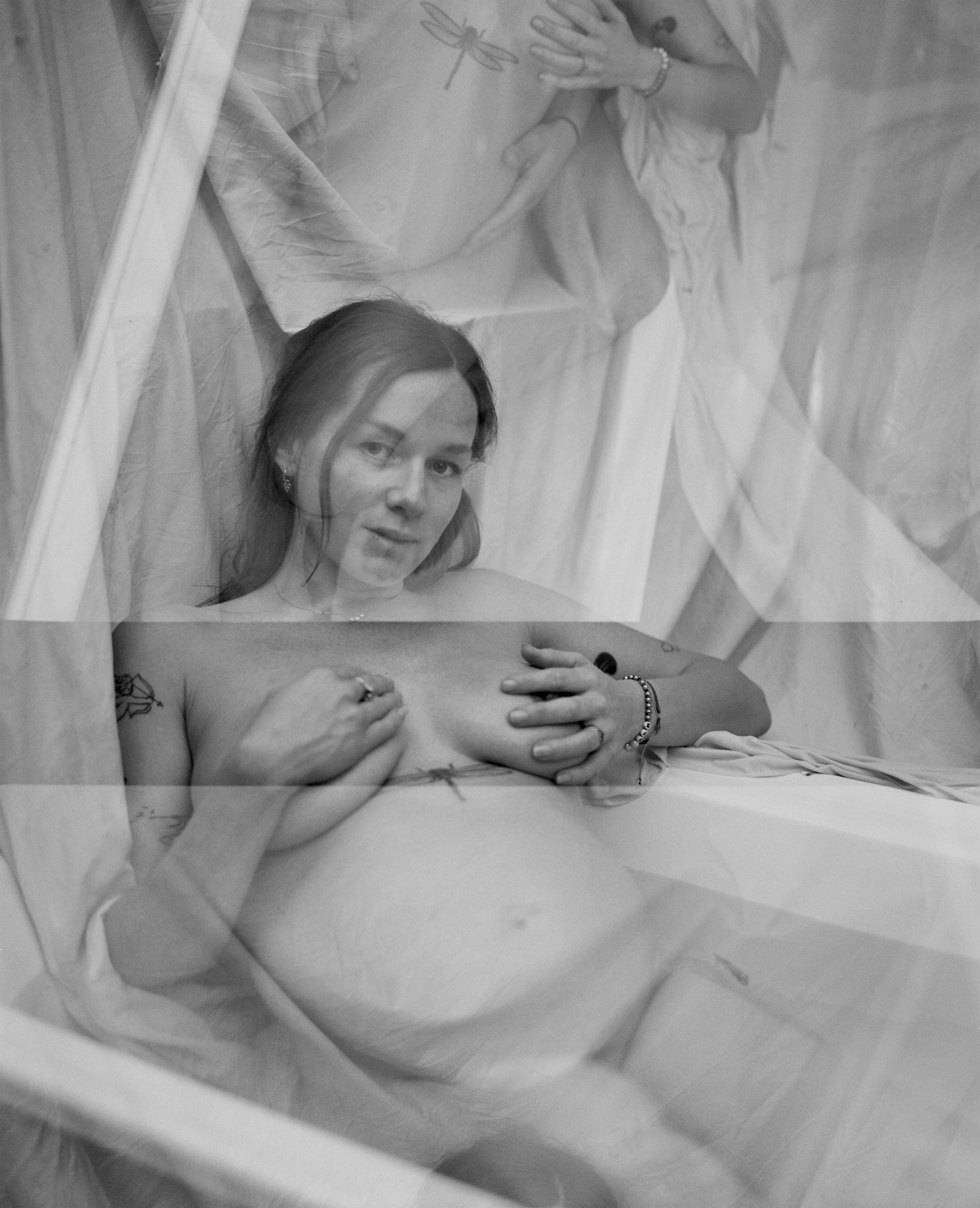 Black and white double-exposure self-portrait, pregnant, by the bath